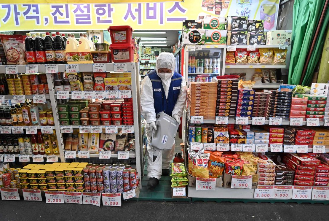 A worker sprays disinfectant to help prevent the spread of the coronavirus in Seoul.