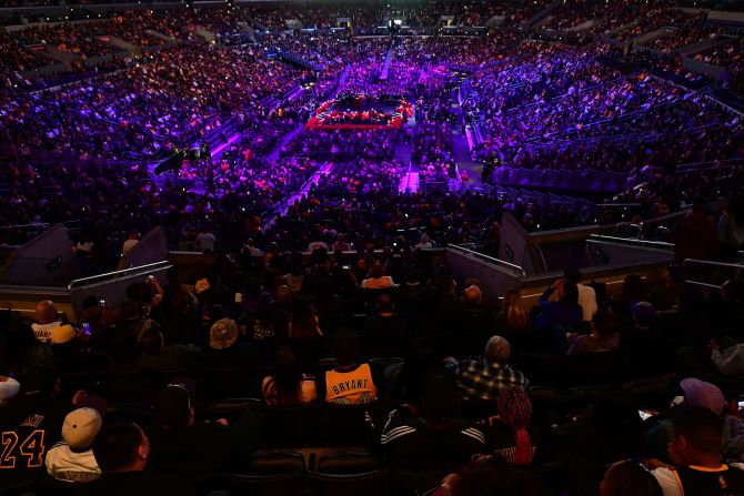 People take their seats inside the Staples Center before the start of the service.
