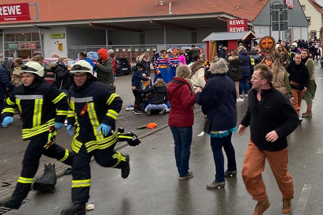 People react at the scene after a car ploughed into a carnival parade in Volkmarsen, Germany.