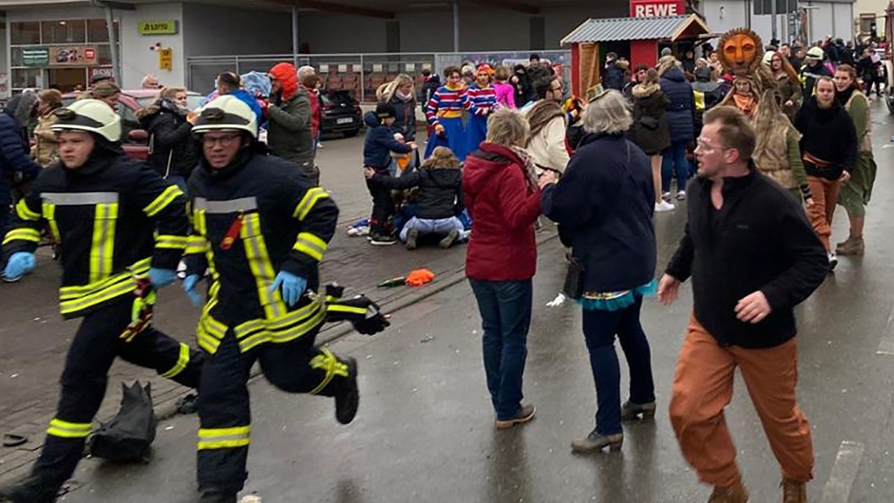 People react at the scene after a car ploughed into a carnival parade in Volkmarsen, Germany.