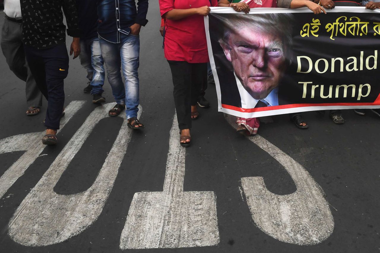 Student activists in Kolkata, India, carry a banner as they protest Trump's visit.