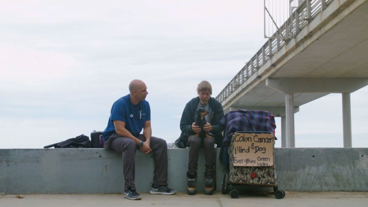 Stewart helping a man with colon cancer and his dog, Crazy Girl.