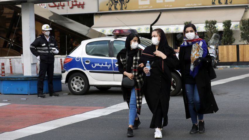 A policeman and pedestrians wear masks to help guard against the Coronavirus, in downtown Tehran, Iran, Sunday, Feb. 23, 2020. On Sunday, Iran's health ministry raised the death toll from the new virus to 8 people in the country, amid concerns that clusters there, as well as in Italy and South Korea, could signal a serious new stage in its global spread. (AP Photo/Ebrahim Noroozi)