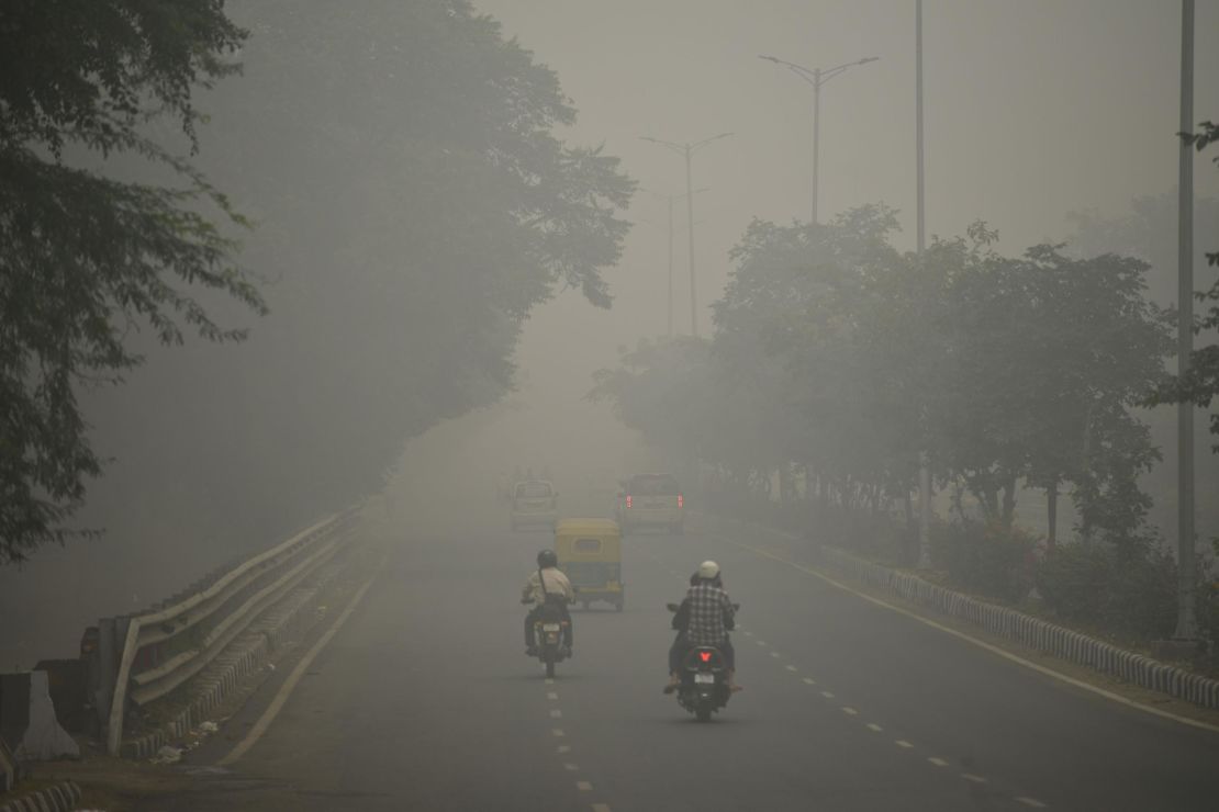 Motorists drive along a road under heavy smog conditions, in New Delhi on November 3, 2019.