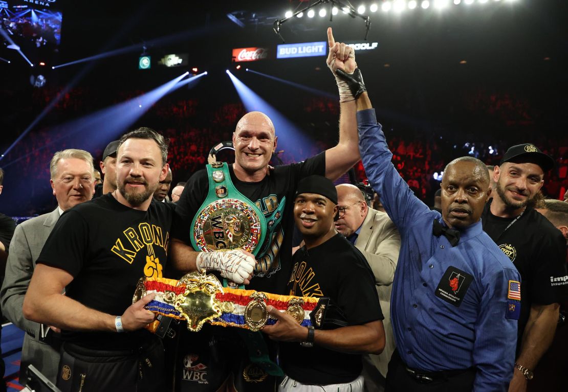 Fury celebrates his win by TKO in the seventh round against Wilder.