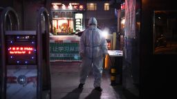 A security guard wears protective clothing as a preventive measure against the COVID-19 coronavirus as he stands at the entrance of a restaurant in Beijing on February 25, 2020. - China on February 25 reported another 71 deaths from the novel coronavirus, the lowest daily number of fatalities in over two weeks, which raised the toll to 2,663. (Photo by Greg Baker/AFP/Getty Images)