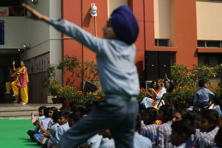 Melania Trump, seen in the background, cheers as a boy does an impromptu dance at a New Delhi school on Tuesday.