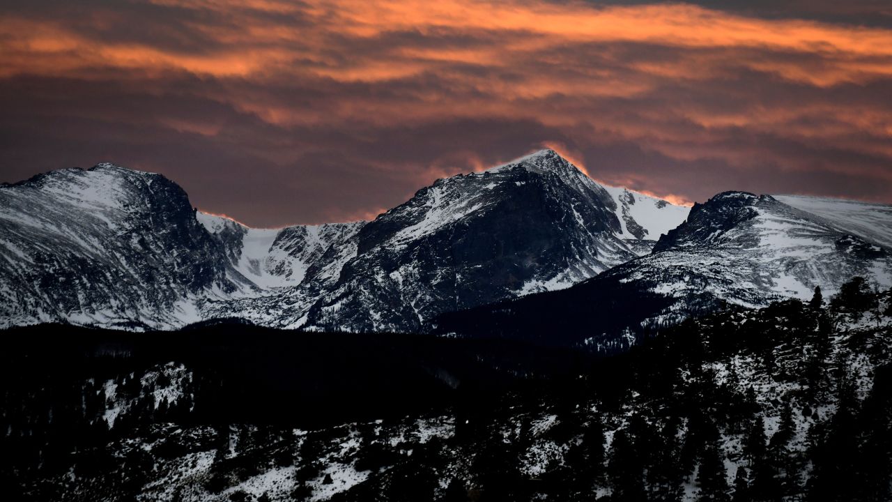 A colorful sunset begins to form over Rocky Mountain National Park in Estes Park, Colorado. 