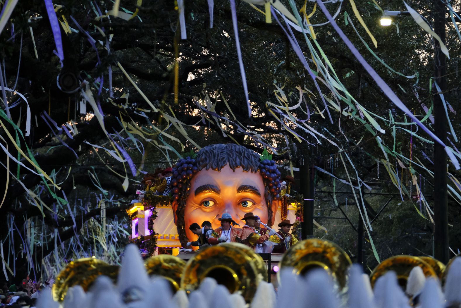 A float in the Krewe of Bacchus parade rolls down the street.