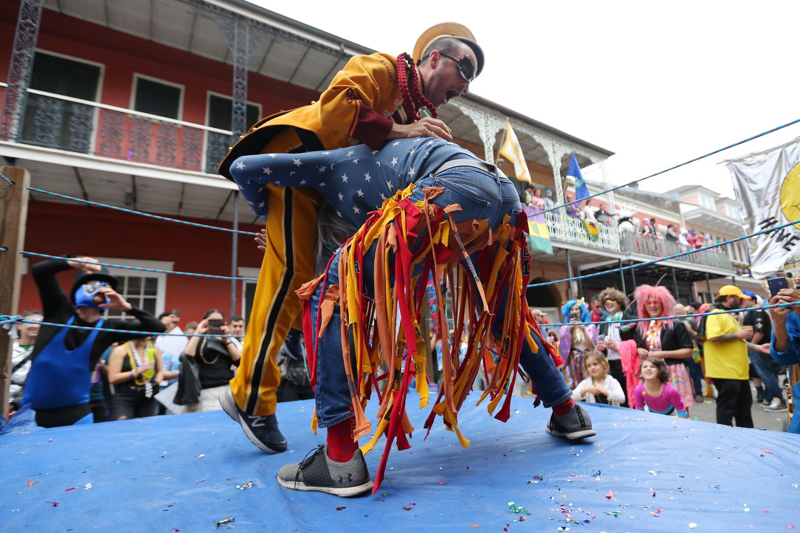 Revelers wrestle during Fat Tuesday celebrations.
