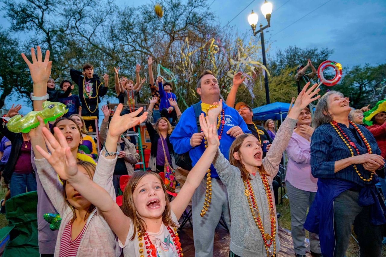 People cry out for beads from floats in the Krewe of Orpheus parade on Napoleon Avenue on Monday.