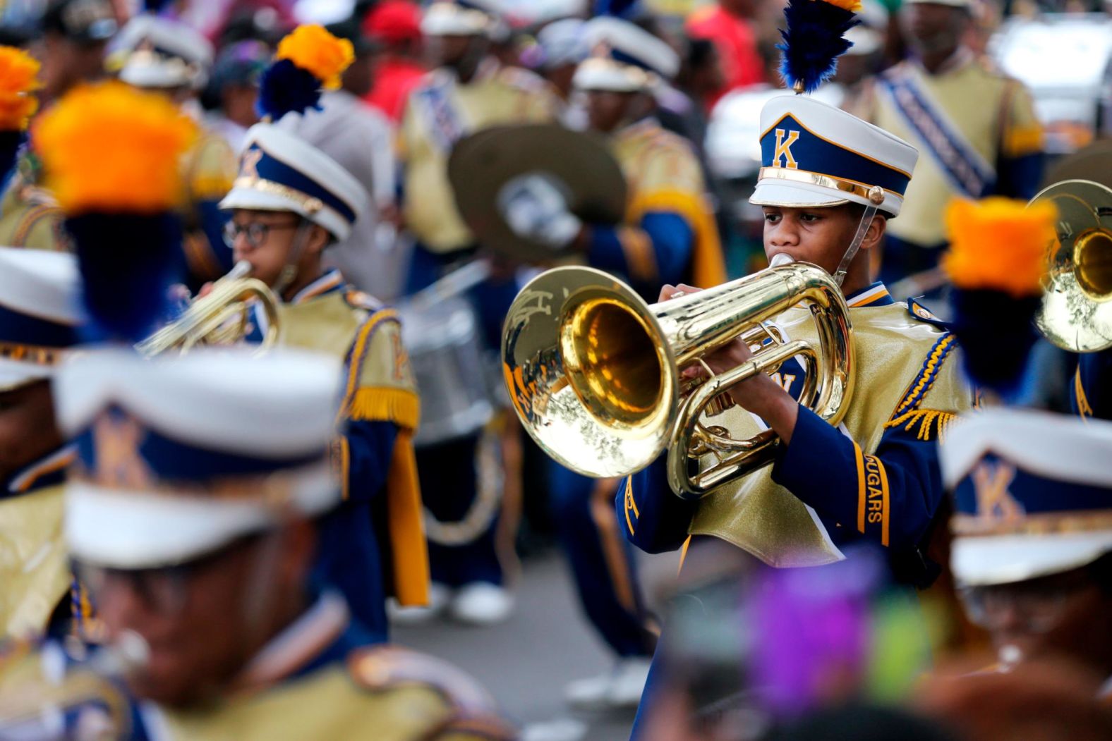 The John F. Kennedy Senior High School Marching Band plays while marching down Jackson Avenue.