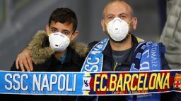 NAPLES, ITALY - FEBRUARY 25: Fans wear medical face masks as they await kick off prior to the UEFA Champions League round of 16 first leg match between SSC Napoli and FC Barcelona at Stadio San Paolo on February 25, 2020 in Naples, Italy. (Photo by Michael Steele/Getty Images)