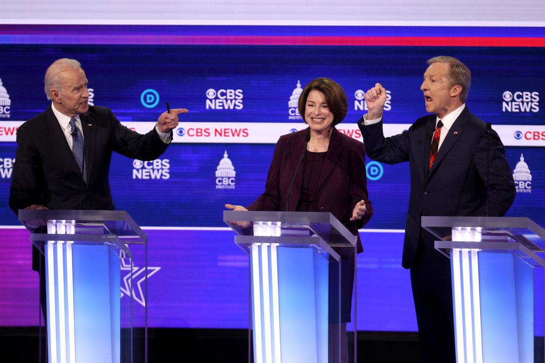 Democratic presidential candidates former Vice President Joe Biden (L) and Tom Steyer (R) debate as Sen. Amy Klobuchar (D-MN) reacts during the Democratic presidential primary debate at the Charleston Gaillard Center on February 25, 2020 in Charleston, South Carolina. 