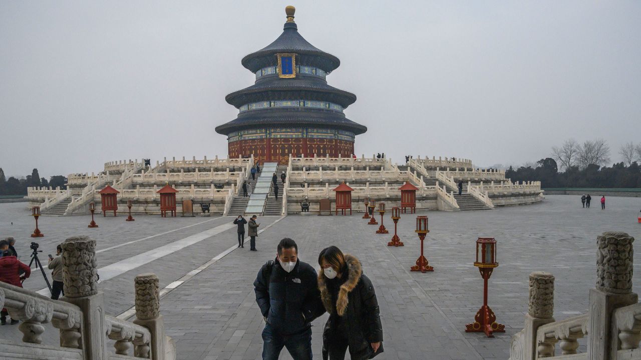 Chinese visitors wear protective masks as they tour the grounds of the Temple of Heaven, which remained open during the Chinese New Year and Spring Festival holiday on January 27, 2020 in Beijing, China.