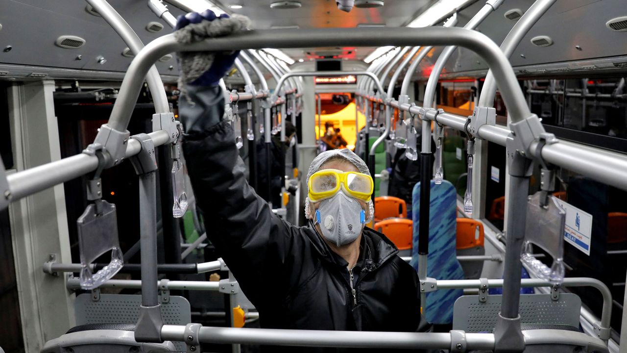 A worker disinfects a public bus amid efforts to contain the coronavirus in Tehran on Wednesday.