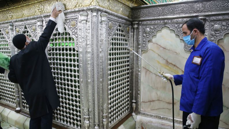 People disinfect Qom's Masumeh shrine in Tehran, Iran, on February 25, 2020.