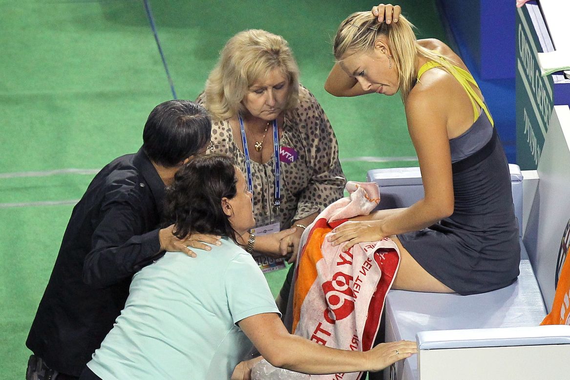 Despite her success, Sharapova also struggled with injuries in the early part of her career, suffering a series of shoulder issues that eventually required surgery in 2008. Here, she receives treatment while facing Petra Kvitova at the Torya Pan Pacific Open in Tokyo in 2011.  