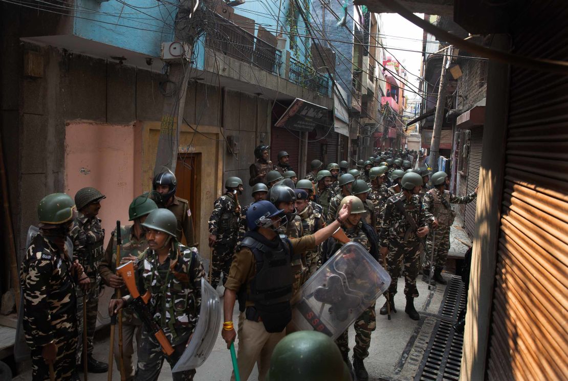 Indian paramilitary force soldiers ask people to go back in their houses after Tuesday's violence.