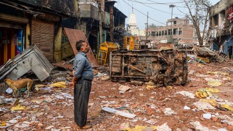 A resident looks at burnt-out buildings following clashes between between Hindus and Muslims in New Delhi on February 26, 2020.
