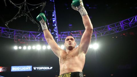 Fury celebrates after knocking down Deontay Wilder during their latest bout.