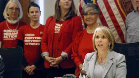 New Mexico Gov. Michelle Lujan Grisham, right foreground, signed legislation that allows state district courts to order the temporary surrender of firearms.