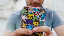 LONDON, ENGLAND - JULY 15:  A player's phone is decorated with Pokemon stickers as he plays Pokemon Go, a mobile game that has become a global phenomenon, the day after it's  UK release on July 15, 2016 in London, England. The app lets players roam using their phone's GPS location data and catch Pokemon to train and battle.The game has added millions to the value of Nintendo, which part-owns the franchise. (Photo by Olivia Harris/Getty Images)