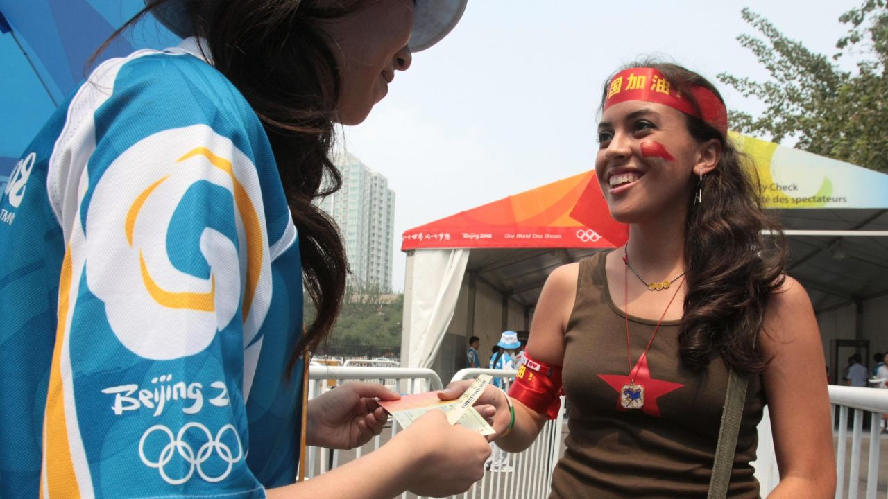 An American tourist presents a ticket at the 2008 Beijing Olympics.