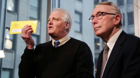 Craig Antico, and Jerry Ashton, co-founders of RIP Medical Debt, talk to reporters in New York in 2018.