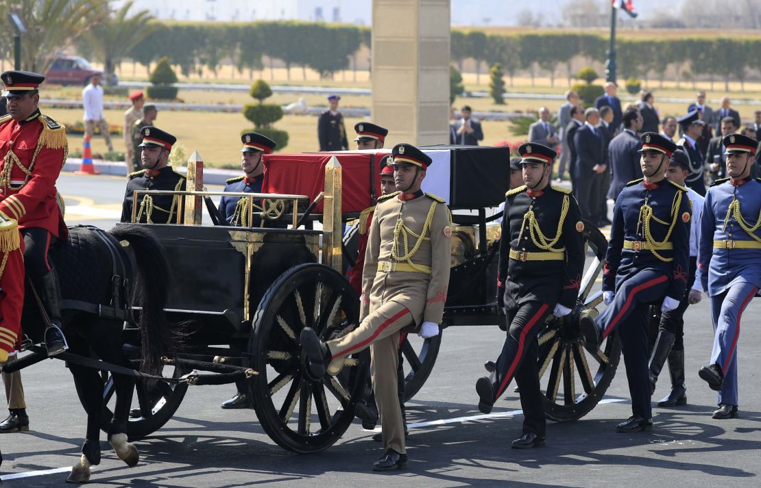 Egyptian honor guards escort the coffin during Mubarak's funeral.