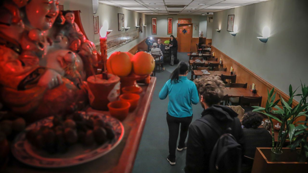A Buddhist prayer shrine sits on a shelf over-looking a near empty Vegetarian Dim Sum restaurant in New York's ChinaTown, usually bustling with afternoon customers, Thursday Feb. 13, 2020, in New York.