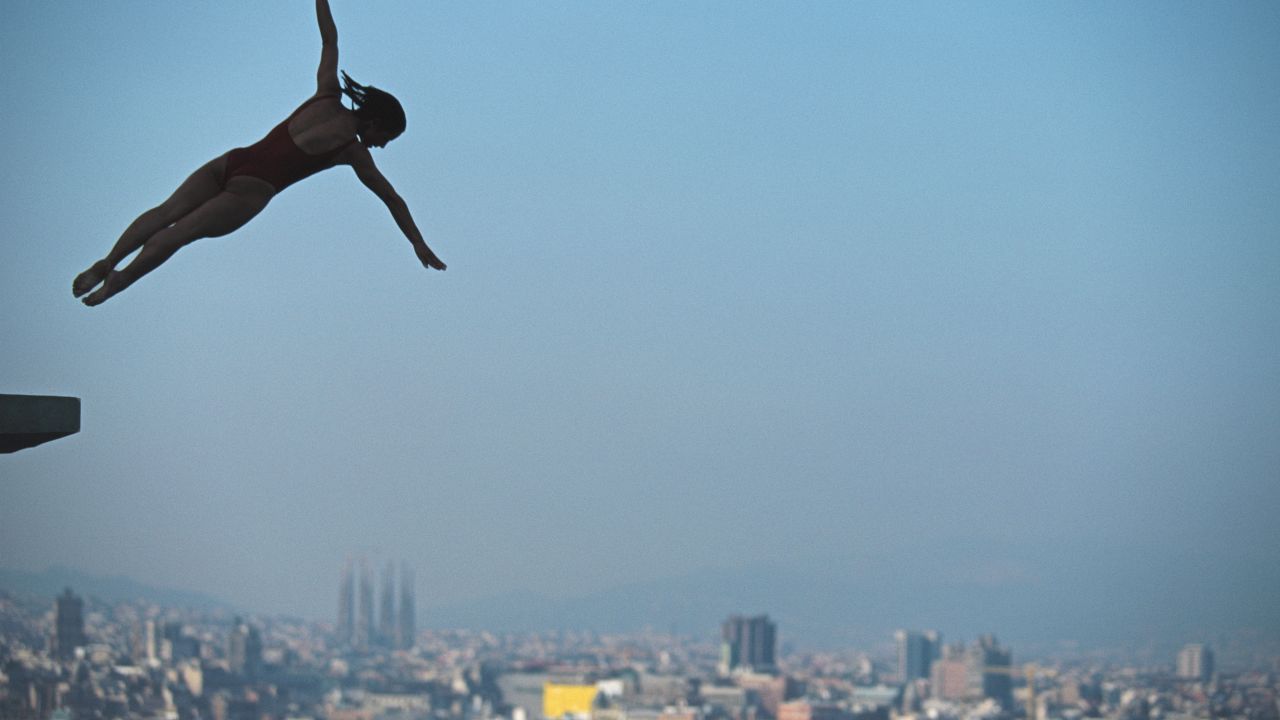 <strong>Olympic heritage: </strong>Barcelona cemented itself as a must-visit tourist destination after the Spanish city hosted the Olympics in 1992. Pictured here: British diver Tracey Miles silhouetted against the city's famous skyline.