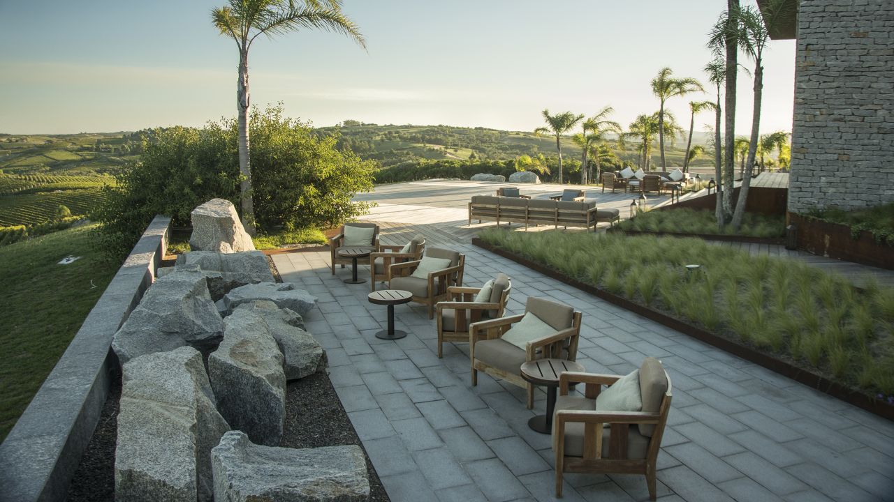 <strong>A glass with a view.</strong> There are several spots on the grounds of Bodega Garzón from which you can enjoy the view with a glass of wine.