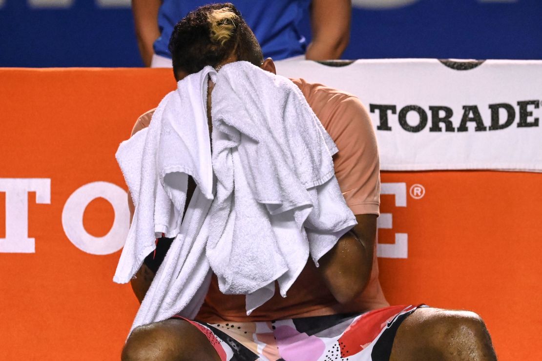 Nick Kyrgios wipes his face before retiring from his Mexican Open.