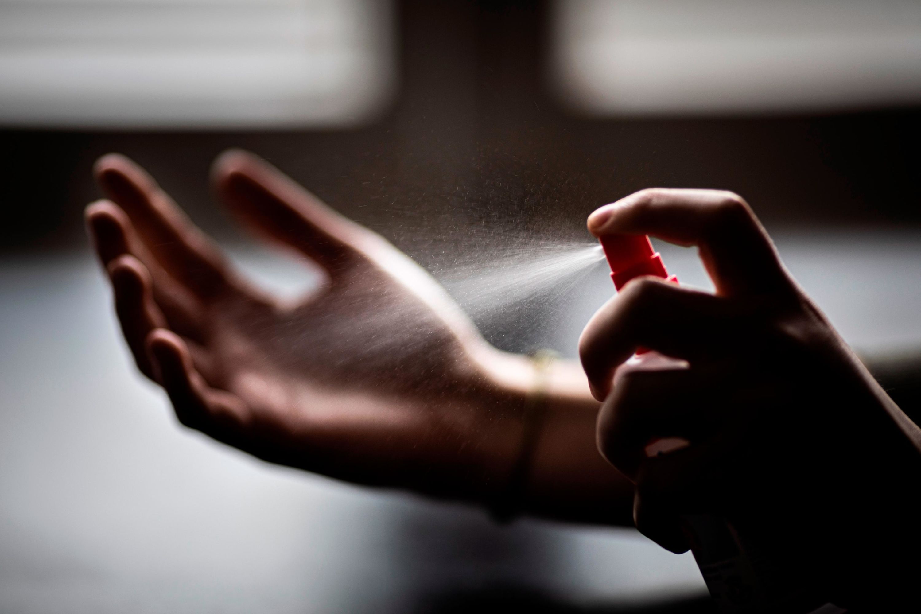 In this photo illustration, a woman sprays disinfectant onto her hands in Berlin, Germany, on February 26. As the novel coronavirus spreads across Asia, people have rushed to stock up on sanitation and cleaning products. In major cities like Hong Kong, stores sold out of hand sanitizer, toilet rolls, face masks, disinfecting wipes, and more.