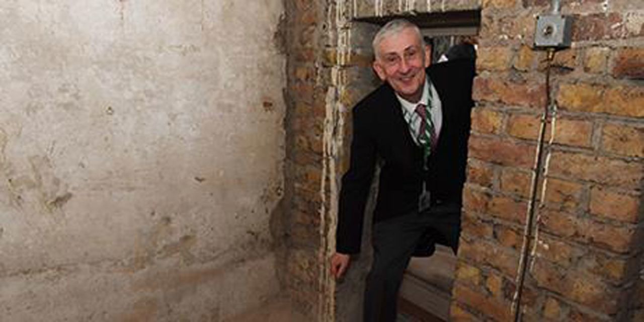 Sir Lindsay Hoyle, Speaker of the House of Commons, poses inside the newly-rediscovered doorframe.