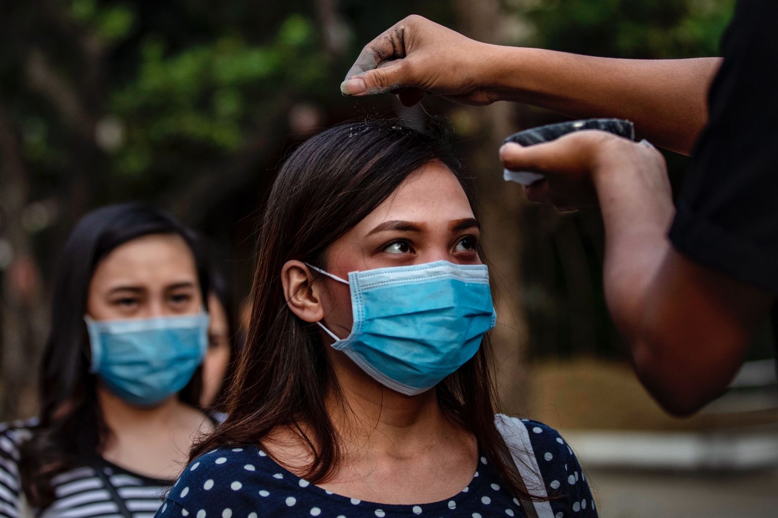 With governments worldwide advising citizens to avoid close physical contact for fears of spreading the virus, even religious services have had to adjust. Catholic devotees in Paranaque city, the Philippines, line up on February 26 to have their head sprinkled with ash during Ash Wednesday services -- instead of the usual practice of having the ash rubbed in.