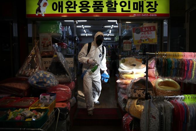 A traditional market in Seoul is disinfected on February 26. The South Korean government raised its coronavirus alert to the highest level, with confirmed case numbers continuing to rise. 