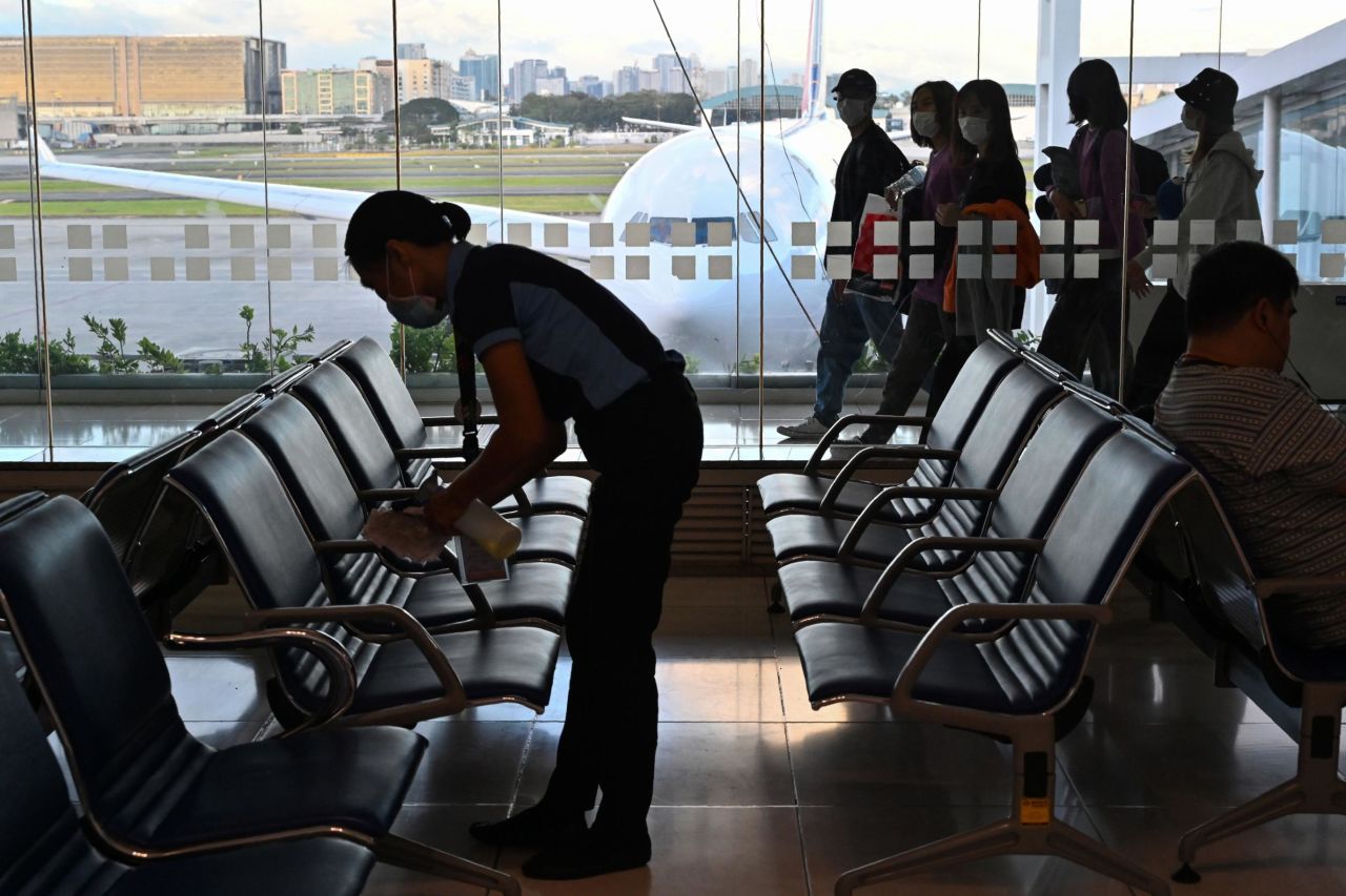A worker at Manila's international airport cleaning chairs at the boarding area on February 23. The Philippines has three confirmed cases and one death from the coronavirus. The country has issued travel restrictions in response to the Asia outbreak; most recently, it announced a ban on travelers from the North Gyeongsang Province of South Korea, where numbers of cases have been climbing.