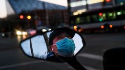 BEIJING, CHINA - FEBRUARY 22: A Chinese man is seen in the side mirror of his scooter as he wears a protective mask while waiting at a red light on February 22, 2020 in Beijing, China. The number of cases of the deadly new coronavirus COVID-19 being treated in China was more than 55000 in mainland China Saturday, in what the World Health Organization (WHO) has declared a global public health emergency. China continued to lock down the city of Wuhan in an effort to contain the spread of the pneumonia-like disease which medicals experts have confirmed can be passed from human to human. In an unprecedented move, Chinese authorities have maintained and in some cases tightened the travel restrictions on the city which is the epicentre of the virus and also in municipalities in other parts of the country affecting tens of millions of people. The number of those who have died from the virus in China climbed to over 2348 on Saturday mostly in Hubei province, and cases have been reported in other countries including the United States, Canada, Australia, Japan, South Korea, India, the United Kingdom, Germany, France and several others. The World Health Organization has warned all governments to be on alert and screening has been stepped up at airports around the world. Some countries, including the United States, have put restrictions on Chinese travelers entering and advised their citizens against travel to China. (Photo by Kevin Frayer/Getty Images)