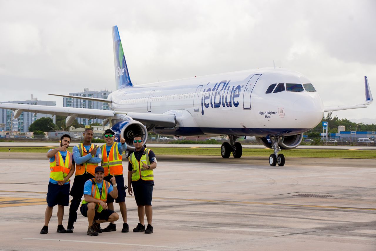 JetBlue employees pose with an Airbus A321 in San Juan, Puerto Rico. JetBlue is the largest airline by market share on the island, eclipsing American Airlines.