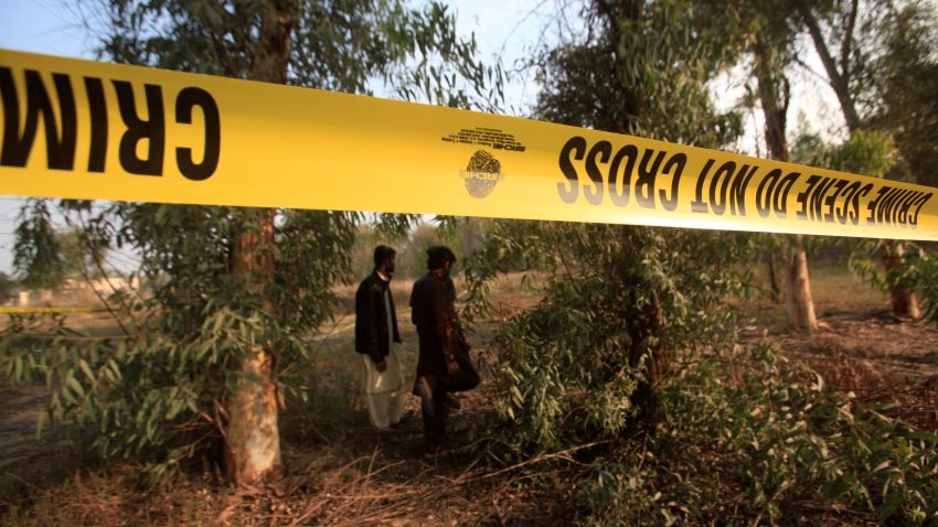 Men walk near a cordoned area, after remains of a teenager, who had been missing for two days, were found in the lions' enclosure at a safari park in Lahore, Pakistan February 26, 2020. REUTERS/Mohsin Raza