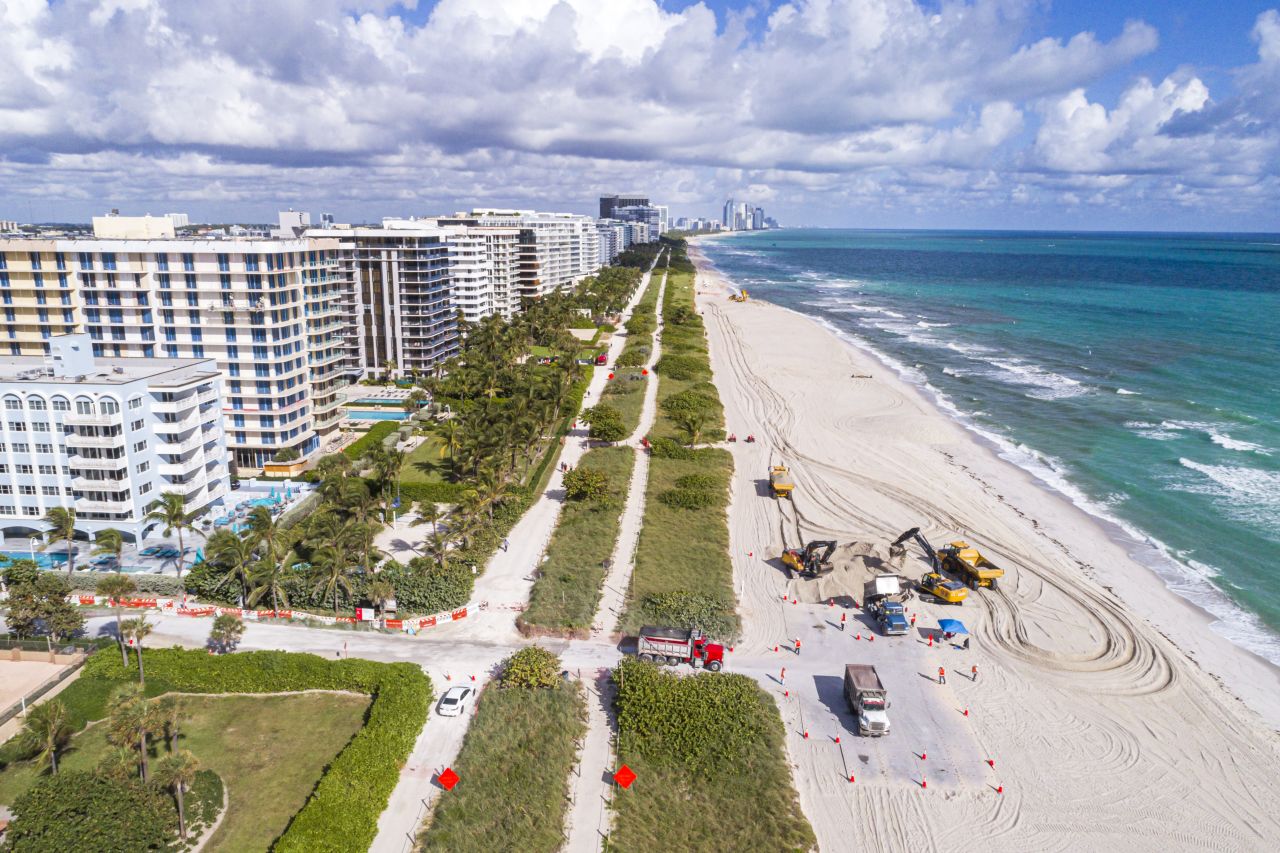 Truckloads of sand are dumped on a beach near Miami to fight erosion. 
