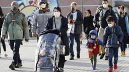 People wear masks near Tokyo Disneyland in Urayasu, eastern Japan, on Feb. 2, 2020, amid the spreading new coronavirus. (Photo by Kyodo News via Getty Images)