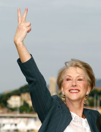 Helen Mirren puts two fingers up in jest as she poses for the cameras during a photocall for the film "Calendar Girls" (May 16, 2003)