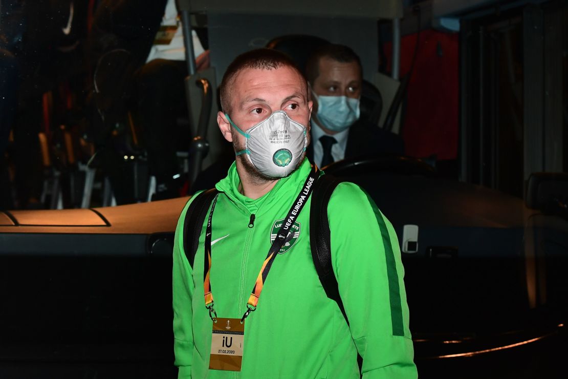 Ludogorets' Romanian defender Cosmin Iosif Moti wears a face mask as he boards the bus on the way to compete in the UEFA Europa League round of 32 against Inter Milan.