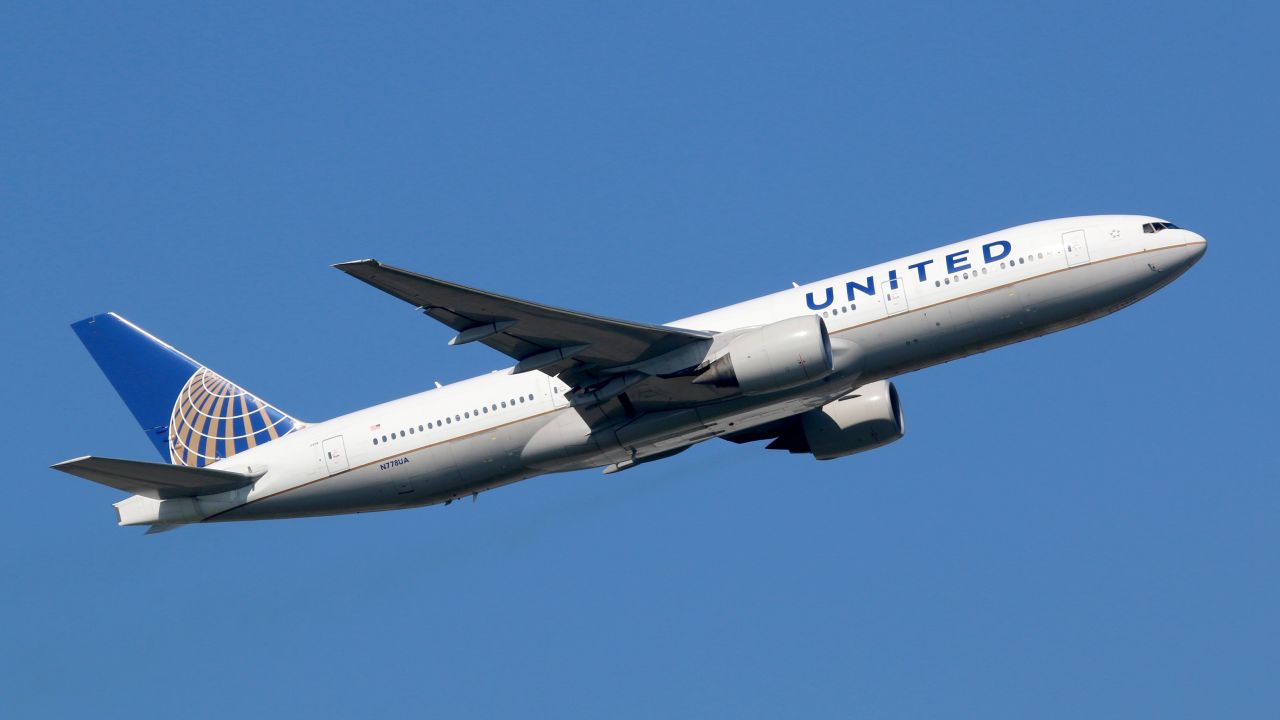 underscored united airlines plane against blue sky