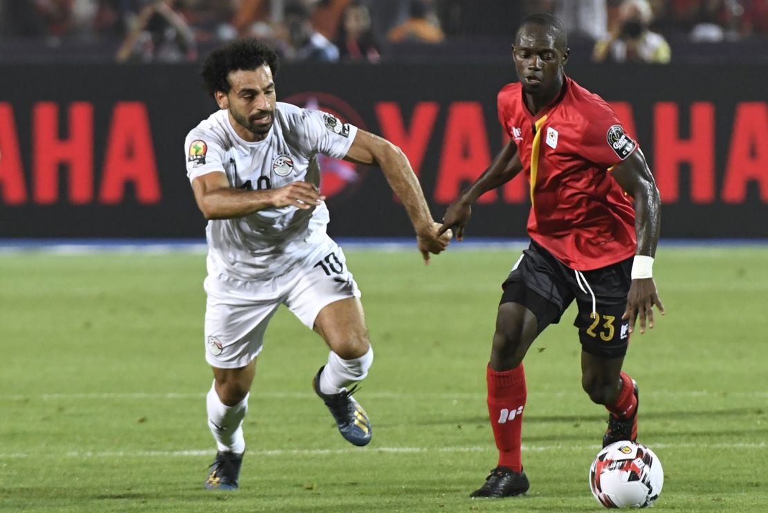 Azira vies for the ball with Egypt's forward Mohamed Salah (L).