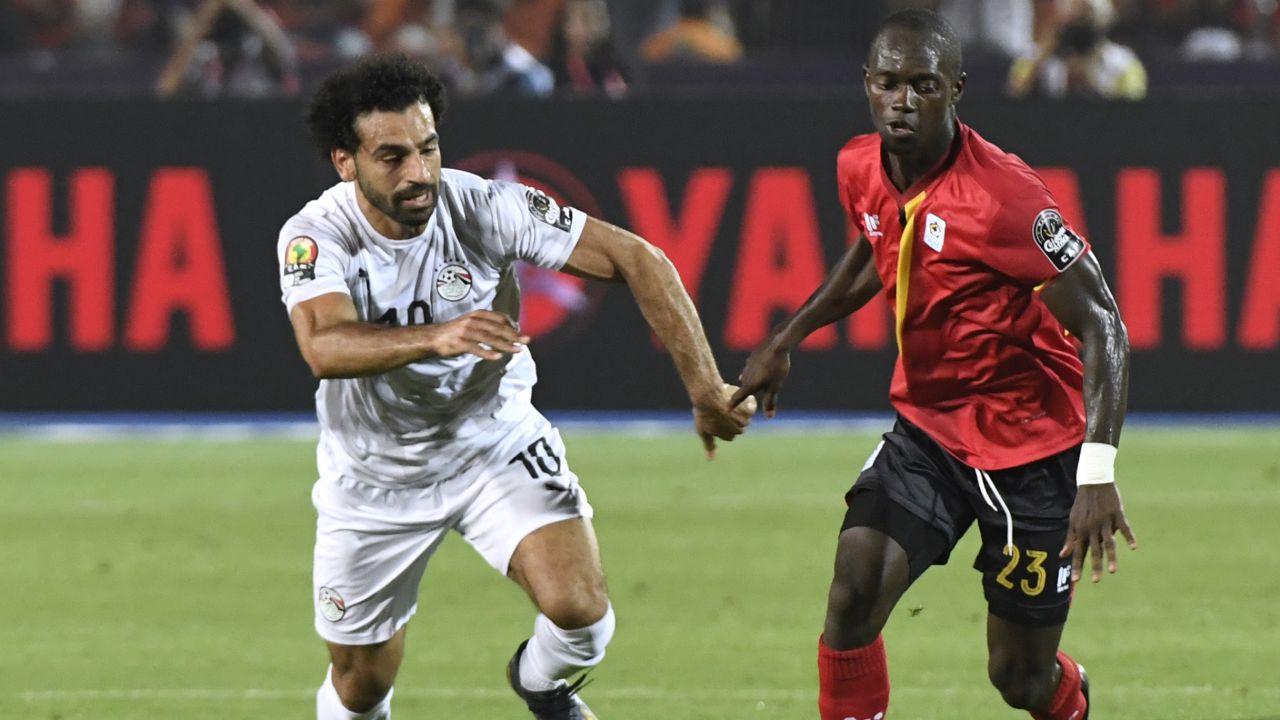 Azira vies for the ball with Egypt's forward Mohamed Salah (L).