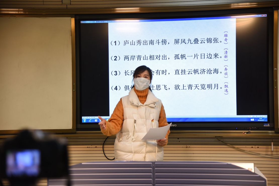 A teacher gives a lecture in front of a camera during an online class at a middle school in Donghai in China's eastern Jiangsu province on February 17, 2020. 